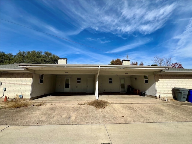 rear view of property with a carport