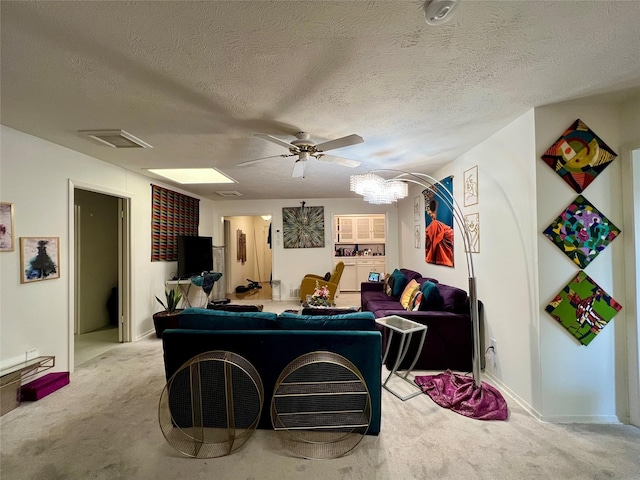 carpeted living room featuring a textured ceiling and ceiling fan