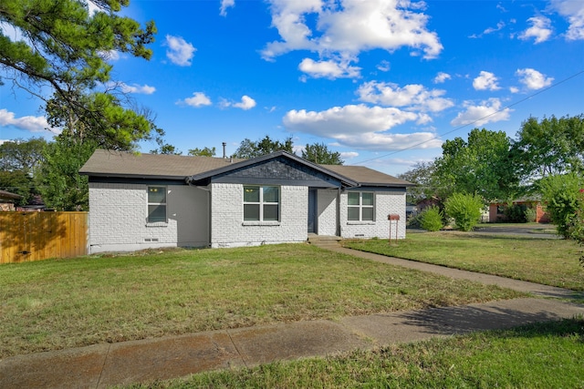 ranch-style home featuring a front yard