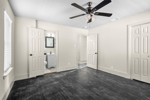 unfurnished bedroom featuring connected bathroom, a closet, ceiling fan, and dark hardwood / wood-style floors