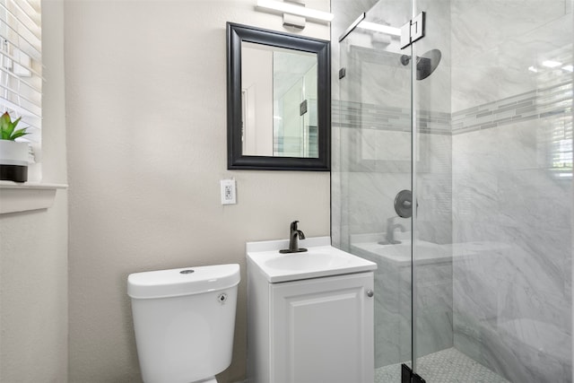 bathroom with vanity, toilet, and walk in shower