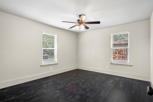 spare room with ceiling fan, dark hardwood / wood-style flooring, and a healthy amount of sunlight