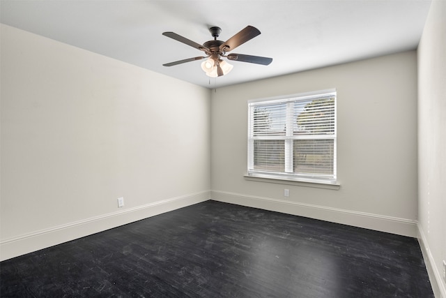 spare room featuring ceiling fan and dark hardwood / wood-style flooring