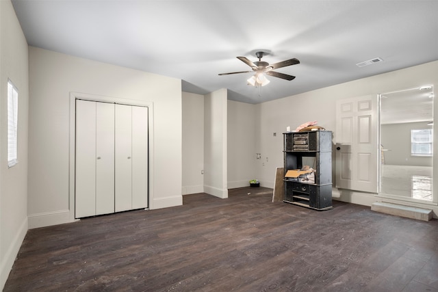 interior space with ceiling fan and dark wood-type flooring