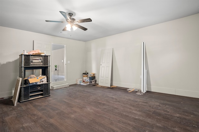 miscellaneous room featuring ceiling fan and dark wood-type flooring