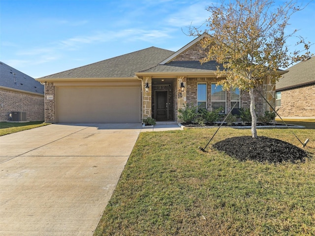 view of front of property with a garage, central AC unit, and a front lawn