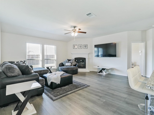 living room featuring ceiling fan and hardwood / wood-style floors