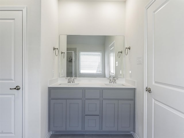 bathroom with tile patterned flooring, vanity, and an enclosed shower