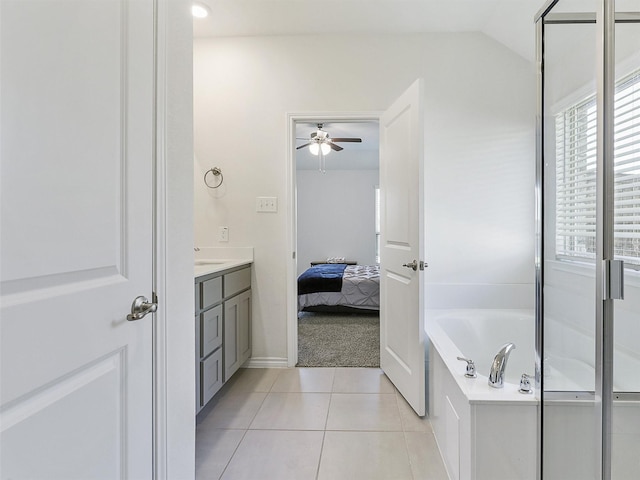 bathroom featuring ceiling fan, tile patterned flooring, vanity, vaulted ceiling, and independent shower and bath