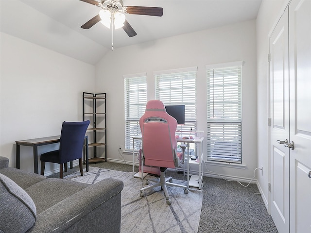 home office with vaulted ceiling, ceiling fan, a healthy amount of sunlight, and carpet floors