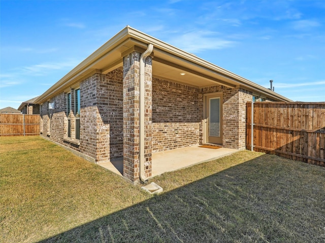 view of property exterior with a lawn and a patio area