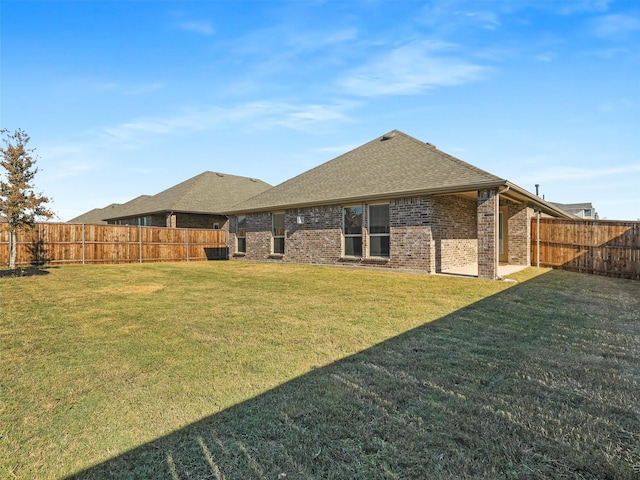 rear view of house featuring a lawn