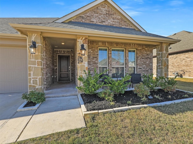 view of exterior entry featuring a porch and a garage