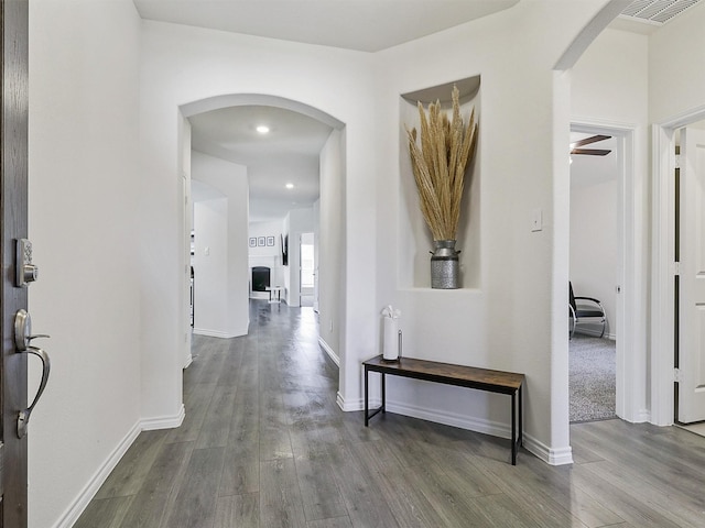 corridor with hardwood / wood-style flooring