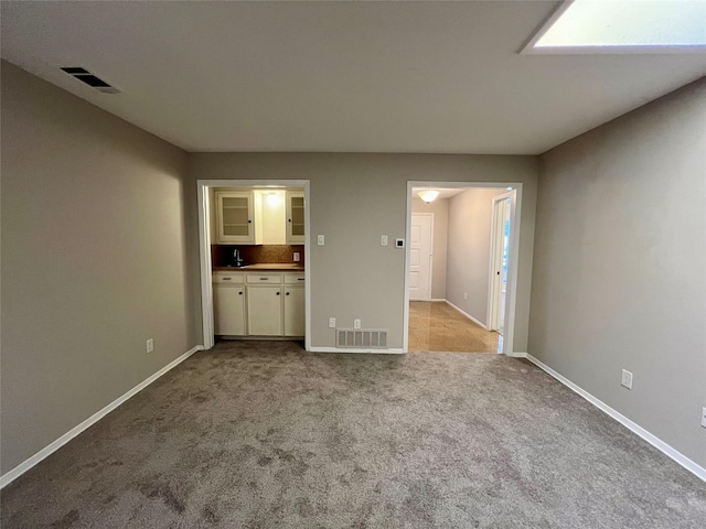 unfurnished living room featuring light colored carpet