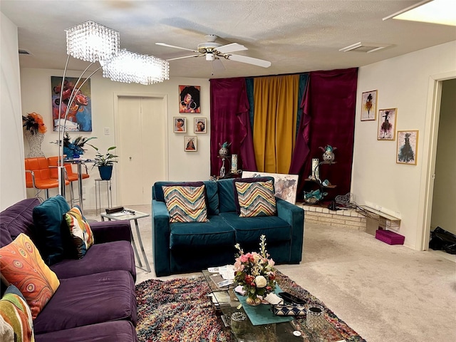 living room featuring carpet flooring, ceiling fan with notable chandelier, and a textured ceiling