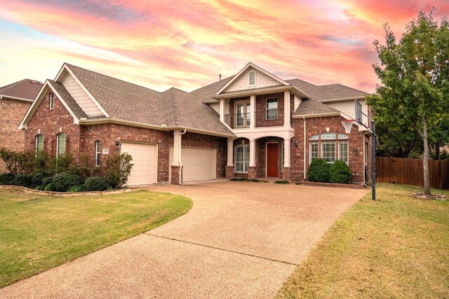 view of front of home featuring a lawn, a garage, and a balcony