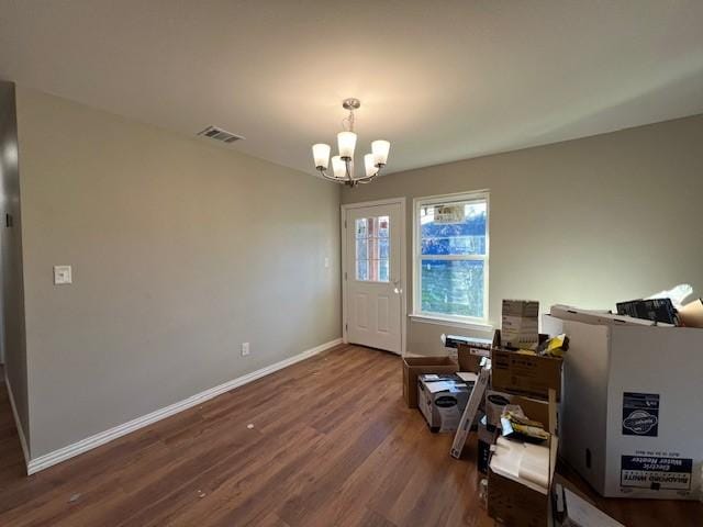 interior space featuring a notable chandelier and dark wood-type flooring