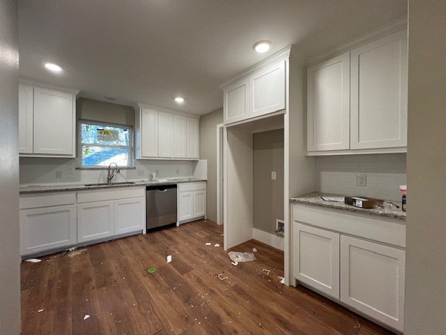 kitchen with dishwasher, white cabinets, dark wood-type flooring, and sink