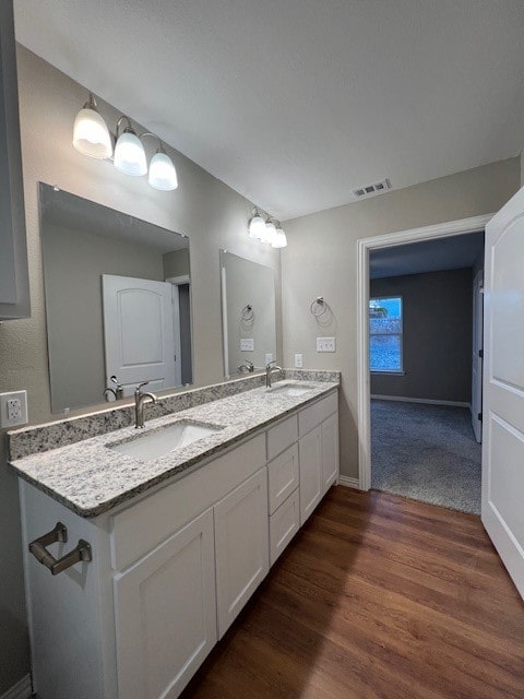 bathroom with vanity and hardwood / wood-style flooring