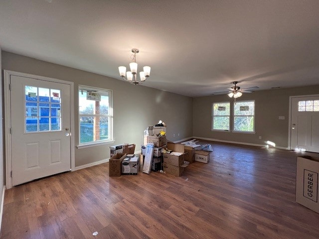 dining area with ceiling fan with notable chandelier, dark hardwood / wood-style floors, and a healthy amount of sunlight