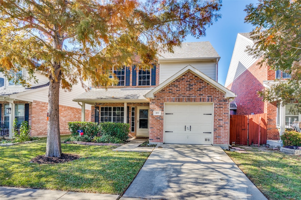 view of front property with a garage and a front lawn