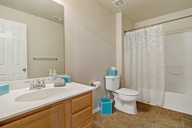 full bathroom featuring tile patterned flooring, visible vents, toilet, and vanity