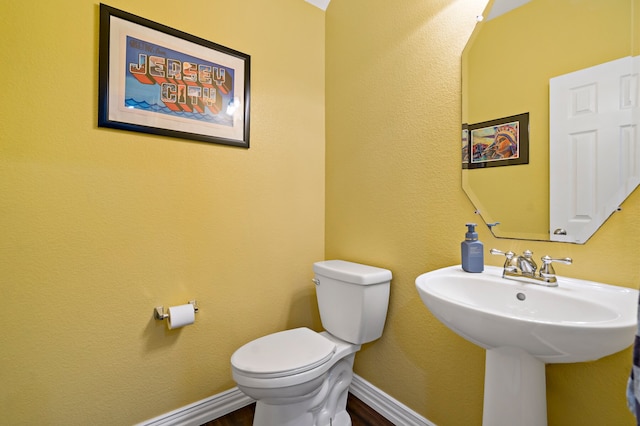 bathroom featuring sink and toilet