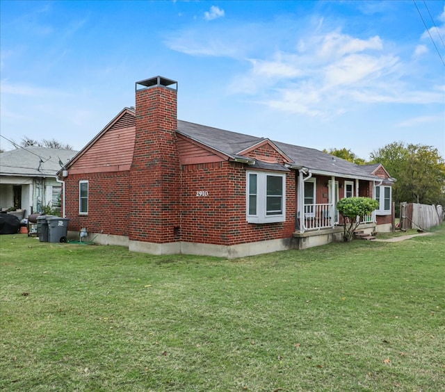 rear view of house featuring a yard