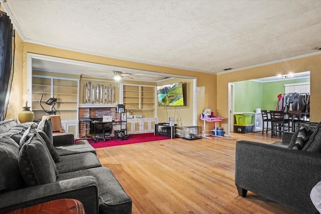 living room featuring hardwood / wood-style floors, crown molding, a textured ceiling, and ceiling fan