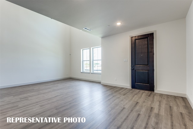 spare room featuring light hardwood / wood-style flooring