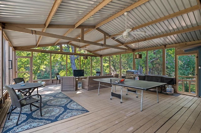 sunroom with lofted ceiling with beams and ceiling fan