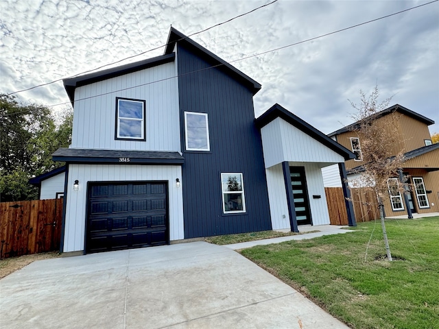 view of front of property featuring a garage and a front lawn