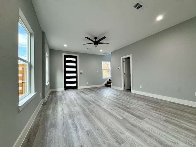 unfurnished living room with ceiling fan and light hardwood / wood-style floors