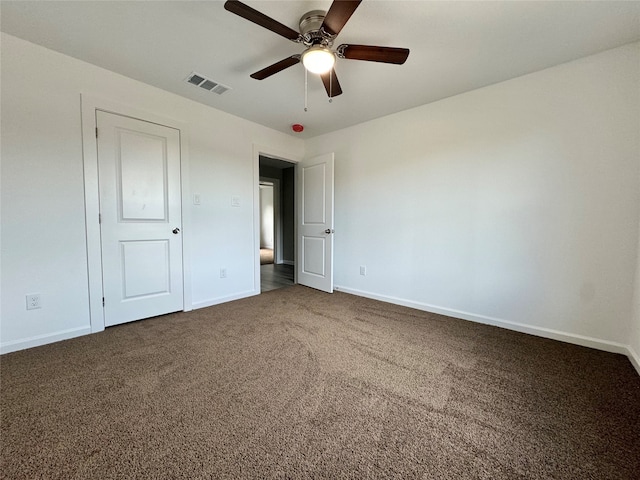 unfurnished bedroom with dark colored carpet and ceiling fan