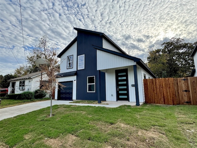 view of front of property with a garage and a front yard