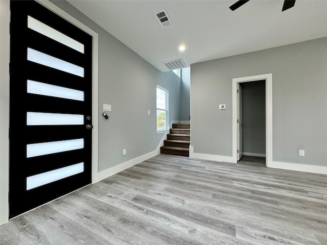 foyer with ceiling fan and light hardwood / wood-style floors