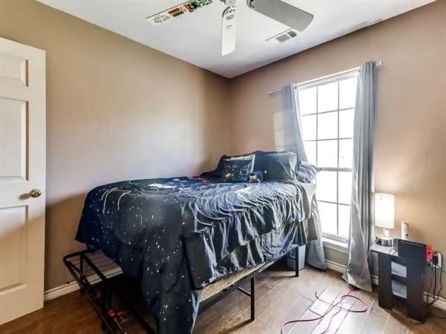 bedroom with wood-type flooring and ceiling fan