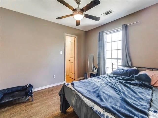 bedroom featuring hardwood / wood-style floors and ceiling fan