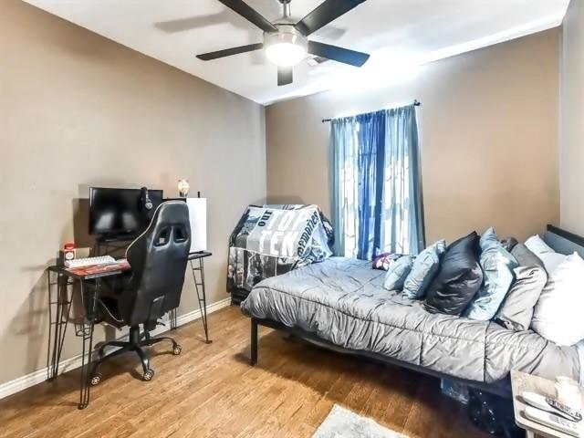 bedroom with wood-type flooring and ceiling fan