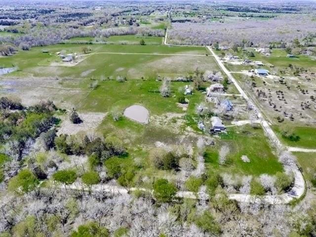 birds eye view of property with a rural view