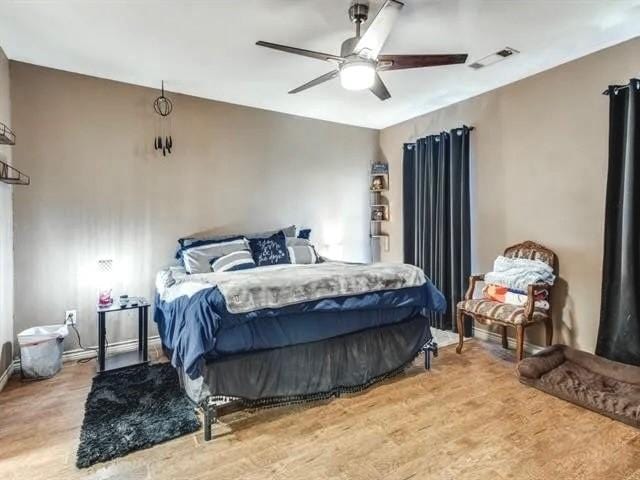 bedroom with hardwood / wood-style floors and ceiling fan