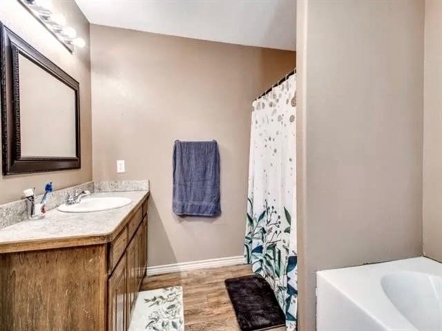 bathroom with vanity and wood-type flooring