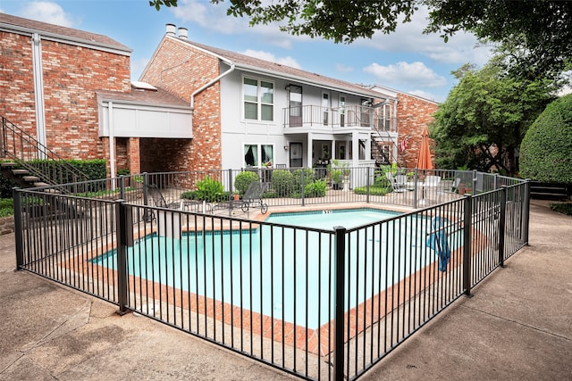 view of swimming pool with a patio