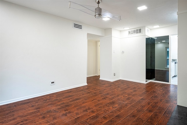 unfurnished room with dark hardwood / wood-style flooring