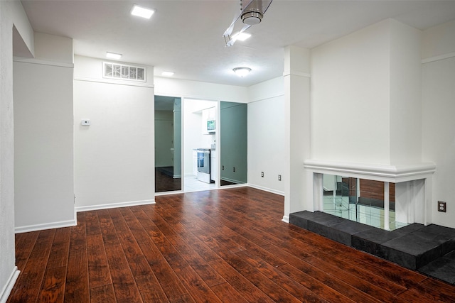 unfurnished living room featuring dark wood-type flooring