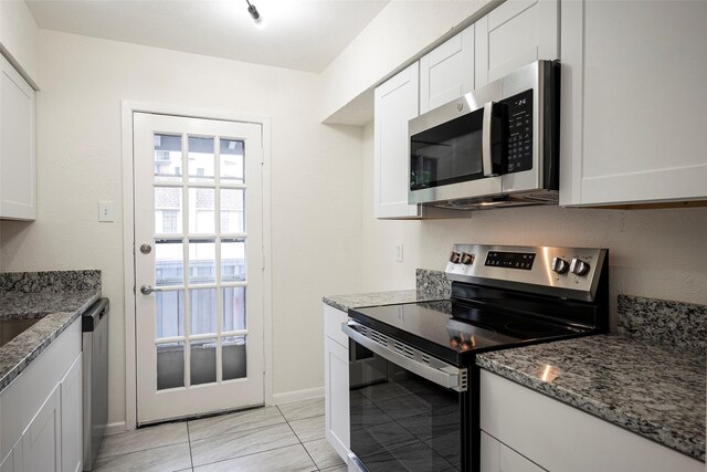 kitchen featuring white cabinets, stainless steel appliances, and stone countertops