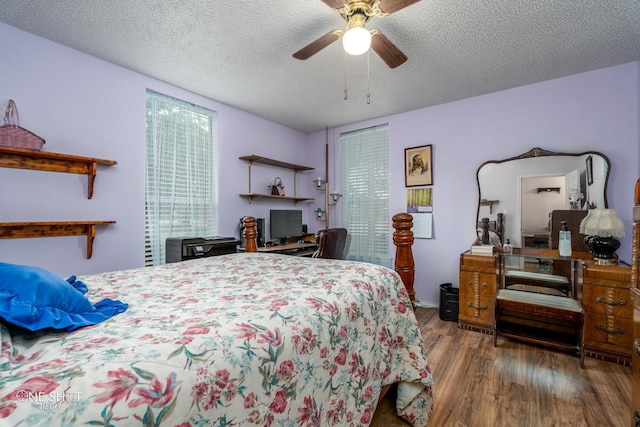 bedroom featuring a ceiling fan, a textured ceiling, and wood finished floors