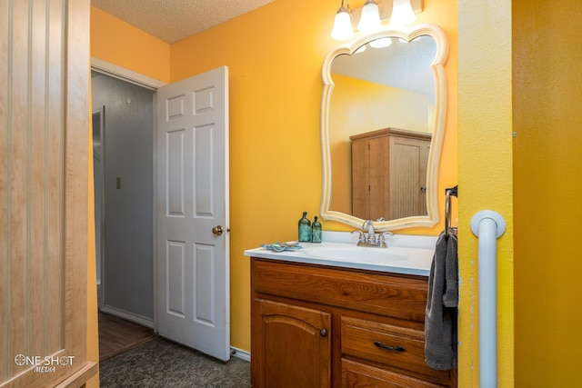 bathroom with a textured ceiling and vanity