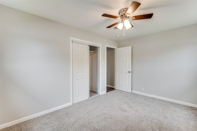 unfurnished bedroom featuring a closet, light colored carpet, and ceiling fan